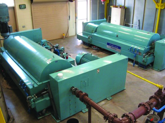 Sludge dewatering centrifuges
