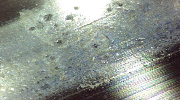 Indentations on the inner race from the same pump (not the outboard bearing). The indentations were more pronounced in the bearing’s outer race. This was caused by contaminants in the oil getting caught between the rolling element and the race. Indentations on the inner race from the same pump (not the outboard bearing). The indentations were more pronounced in the bearing’s outer race. This was caused by contaminants in the oil getting caught between the rolling element and the race.