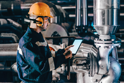 Trained maintenance technician monitoring a plant