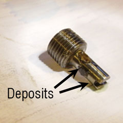 This orifice plug from a boiler feed pump turbine control has deposits covering the orifice holes.