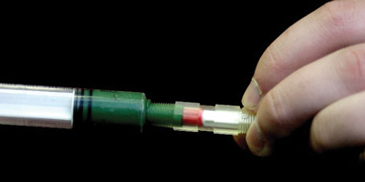 Figure 3: Filled syringe injecting grease into the Passive Grease Sampling Device