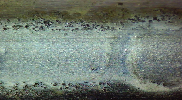 Damage to a centrifugal pump’s outboard bearing outer race was the result of dirty oil. Contaminants between the race and the rolling element made indentations in both the race and rolling element.